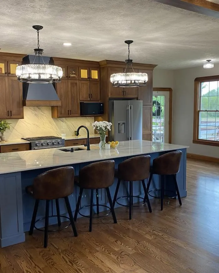 Full view of slate blue island kitchen with walnut perimeter cabinetry