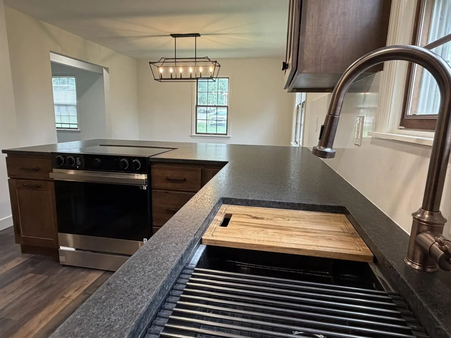 Honed stone countertop detail with integrated sink and cutting board