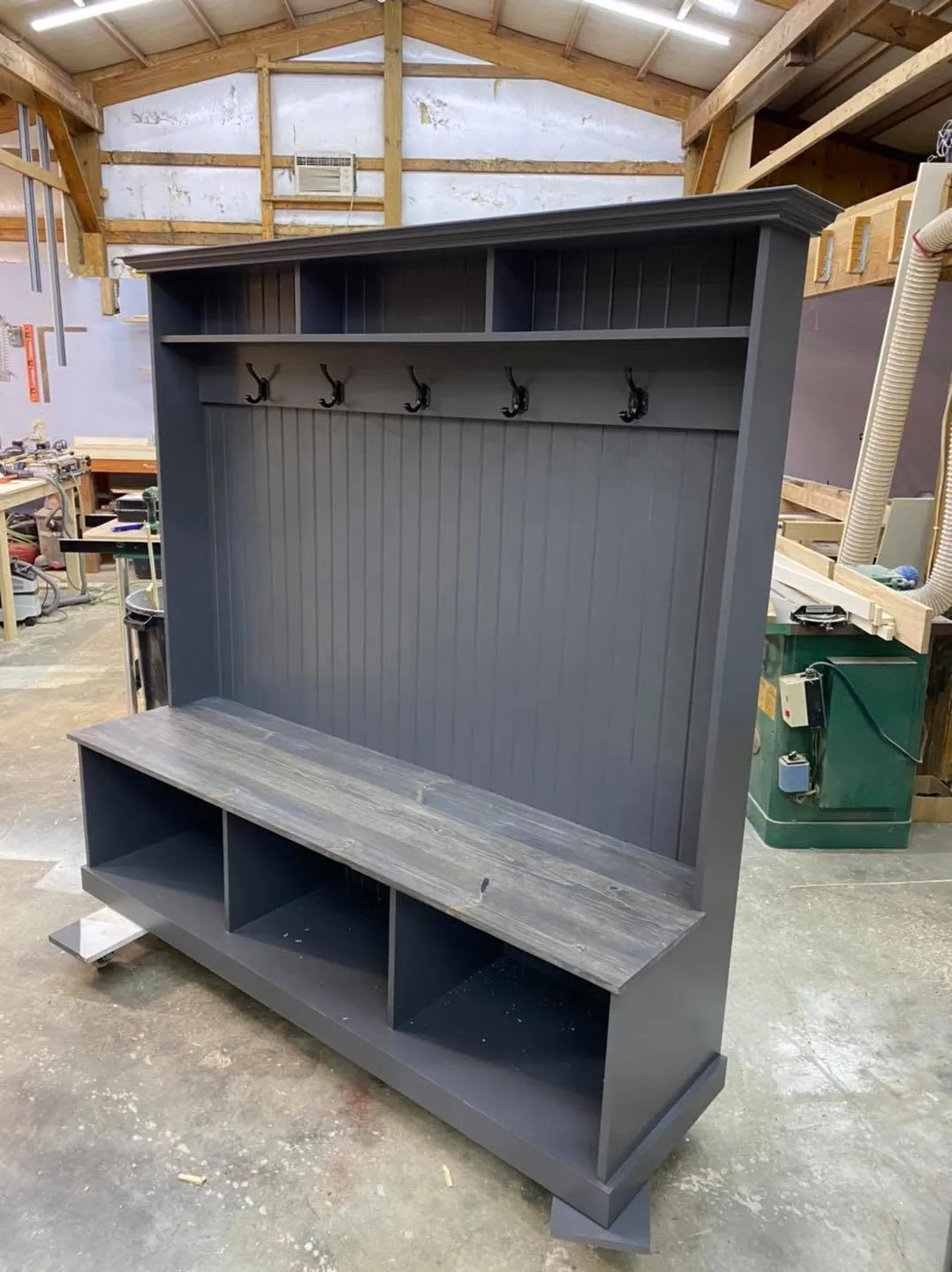 Gray painted hall tree with coat hooks and cubby bench