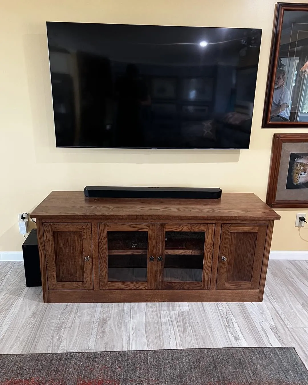Custom oak TV media console with glass and paneled cabinet doors