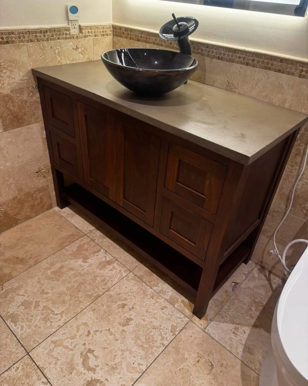 Custom walnut bathroom vanity with vessel sink and concrete countertop