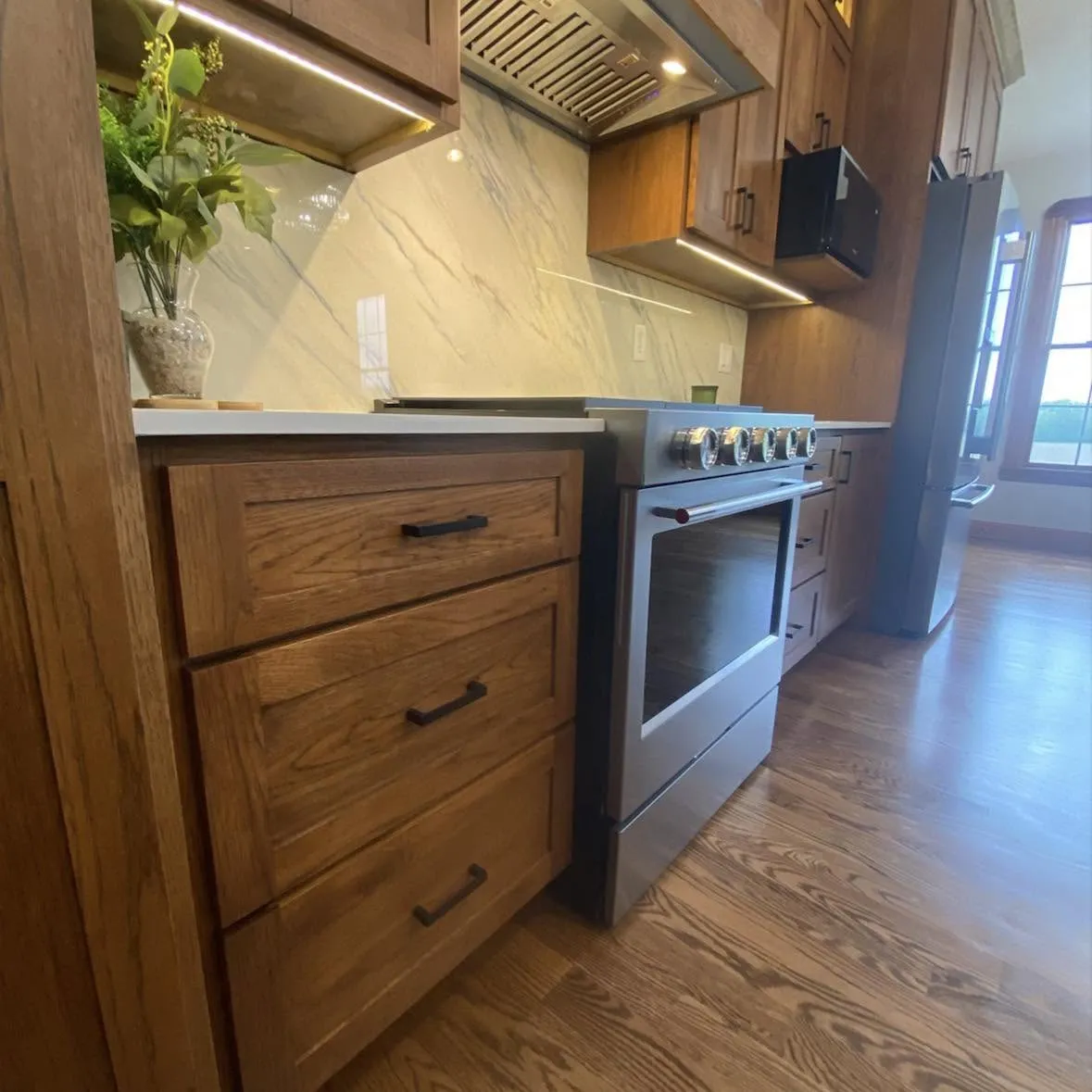 Custom walnut drawer stack detail with matte black pulls