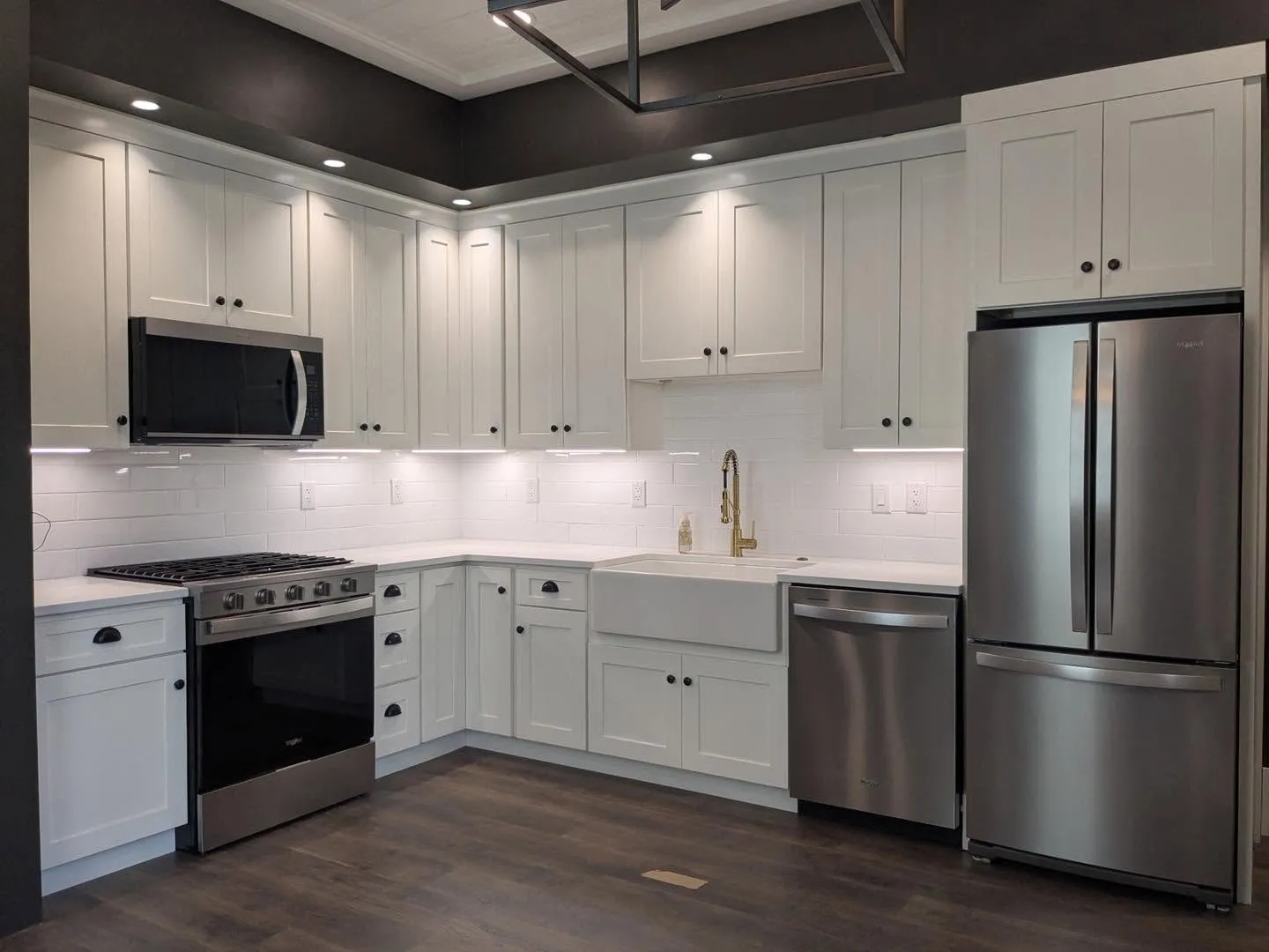 Bright white shaker cabinetry kitchen with matte black ceiling accent