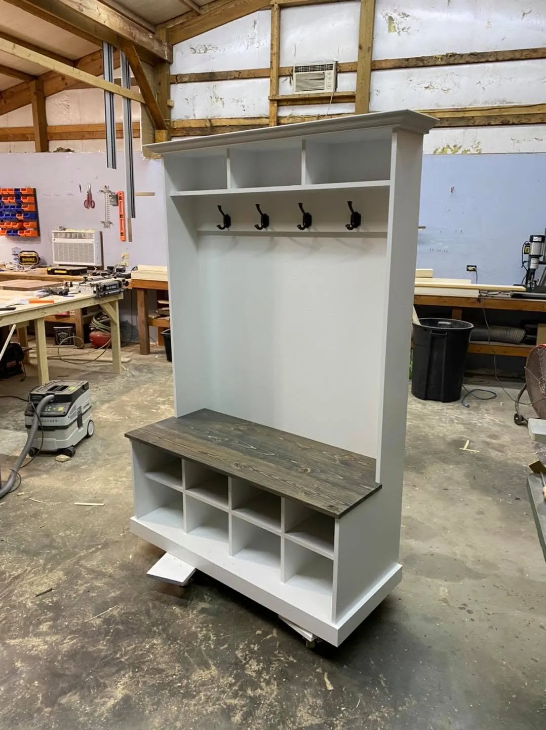 White painted hall tree with coat hooks and cubby bench