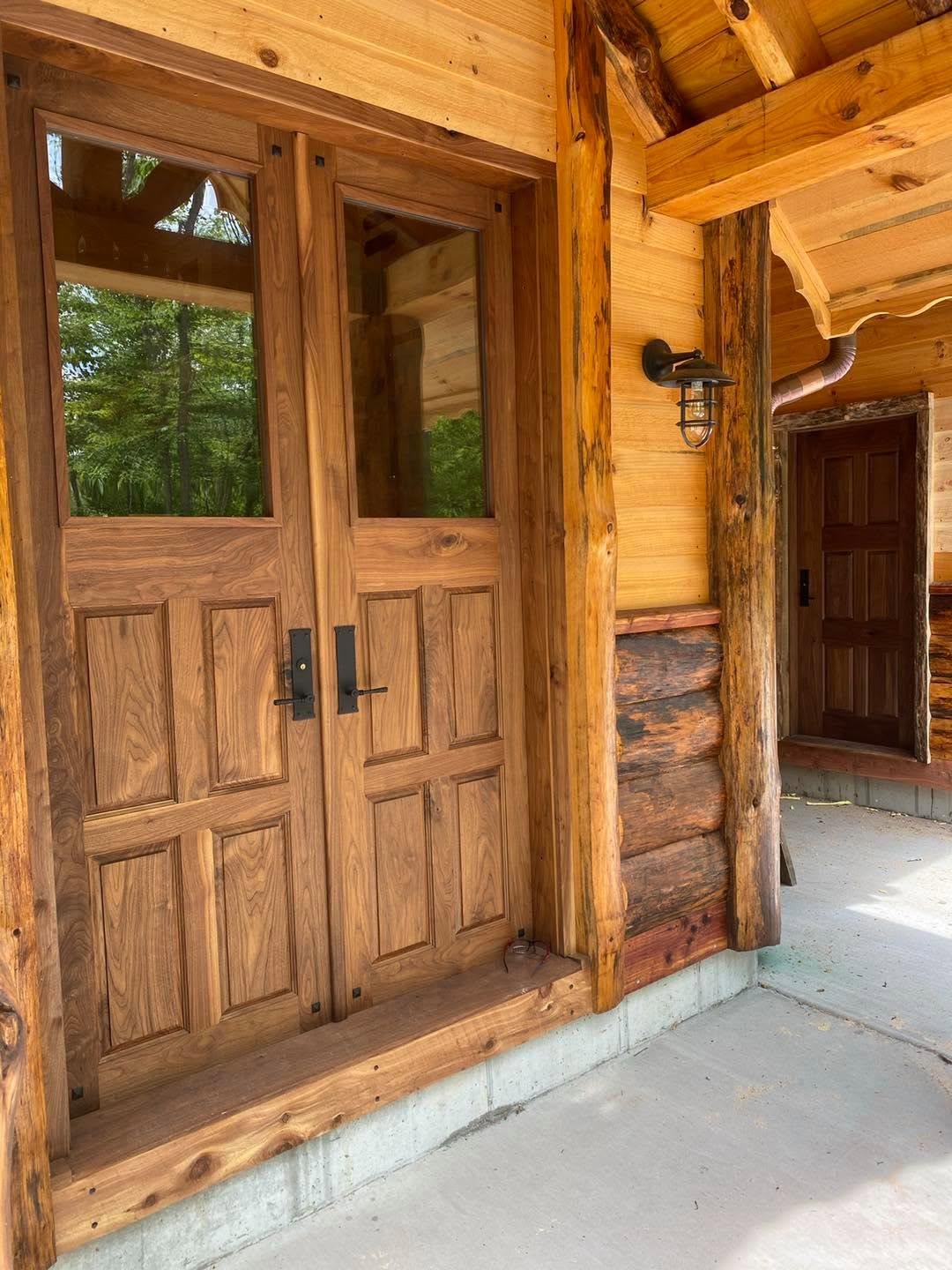 Custom walnut double entry doors with glass panels
